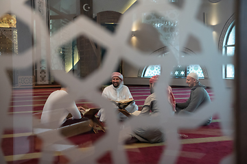 Image showing muslim people in mosque reading quran together