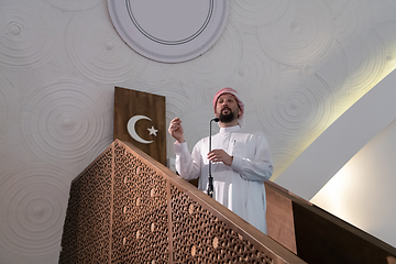 Image showing Muslims young arabic Imam has a speech on friday afternoon prayer in mosque.