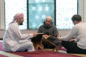 Image showing muslim people in mosque reading quran together