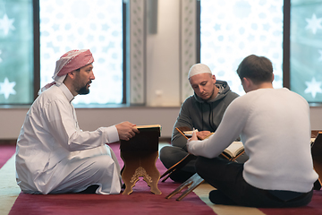 Image showing muslim people in mosque reading quran together