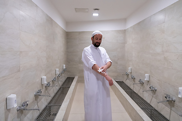 Image showing a portrait of a man in abdesthana using a towel