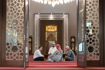 Image showing muslim people in mosque reading quran together