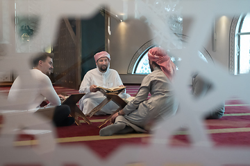 Image showing muslim people in mosque reading quran together