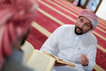 Image showing two muslim people in mosque reading quran together concept of islamic education