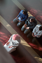 Image showing group of muslim people praying namaz in mosque.