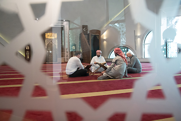 Image showing muslim people in mosque reading quran together