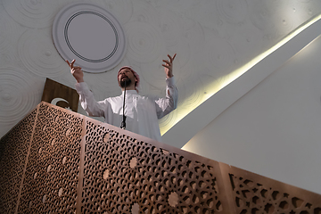 Image showing Muslims young arabic Imam has a speech on friday afternoon prayer in mosque.