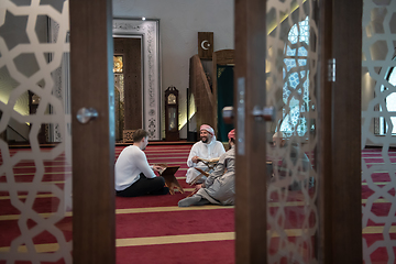 Image showing muslim people in mosque reading quran together