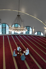 Image showing muslim people in mosque reading quran together