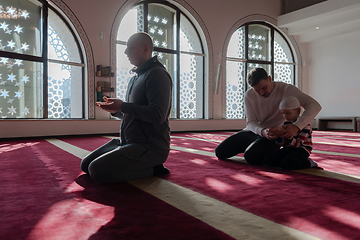 Image showing muslim prayer father and son in mosque praying and 