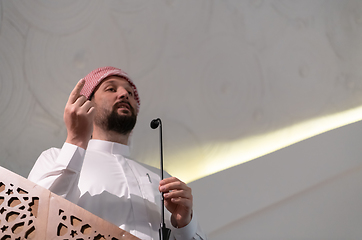 Image showing Muslims young arabic Imam has a speech on friday afternoon prayer in mosque.