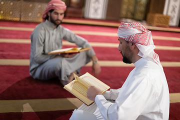 Image showing two muslim people in mosque reading quran together concept of islamic education