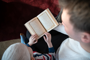 Image showing  father and son in mosque praying and reading holly book quran together islamic education concept