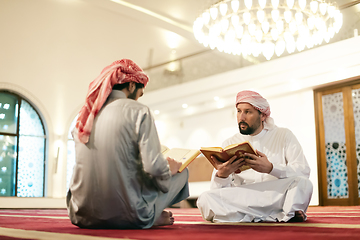 Image showing two muslim people in mosque reading quran together concept of islamic education