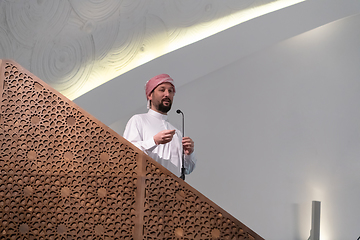 Image showing Muslims young arabic Imam has a speech on friday afternoon prayer in mosque.