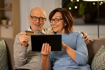 Image showing happy senior couple with tablet pc and credit card