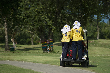 Image showing Two caddies on a golf cart