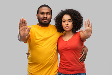 Image showing african american couple showing stop gesture