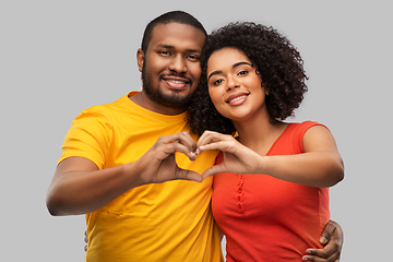 Image showing happy african american couple making hand heart