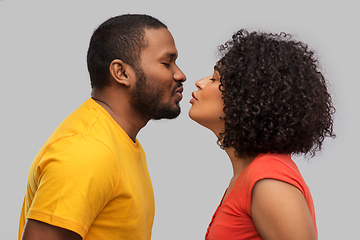 Image showing happy african american couple reaching for kiss