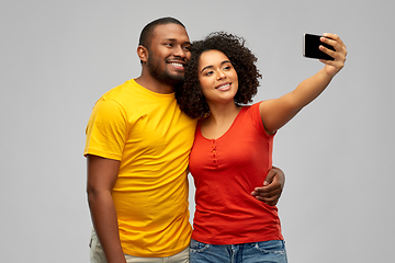 Image showing african american couple takes selfie by smartphone