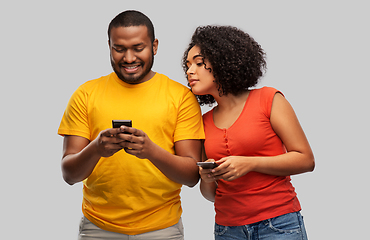 Image showing happy african american couple with smartphones