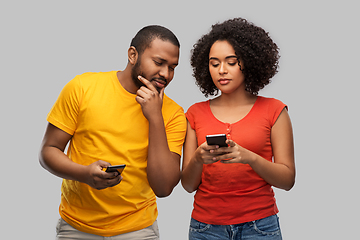 Image showing happy african american couple with smartphones