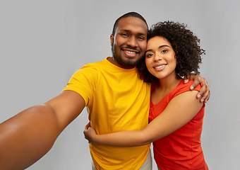 Image showing happy smiling african american couple takes selfie