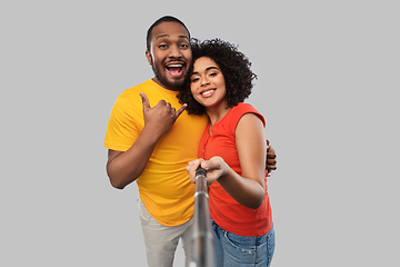 Image showing african couple taking picture by selfie stick