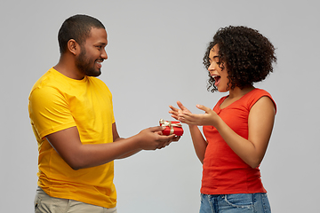 Image showing happy african american couple with red gift box
