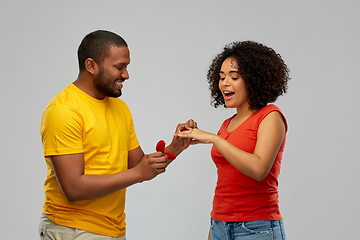 Image showing african american man giving woman engagement ring