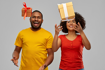 Image showing happy african american couple throwing gift boxes