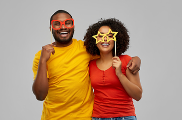 Image showing happy african american couple with party props