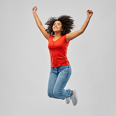 Image showing smiling african american woman man jumping in air