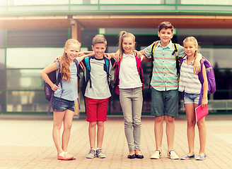 Image showing group of happy elementary school students hugging