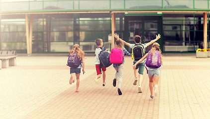 Image showing group of happy elementary school students running