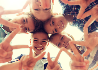 Image showing group of happy children showing v sign in circle