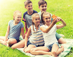 Image showing happy kids or friends taking selfie in summer park