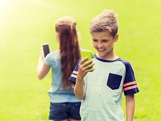 Image showing kids with smartphones playing game in summer park