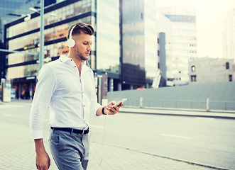 Image showing man with headphones and smartphone listening music