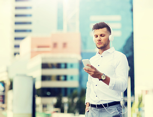 Image showing man with headphones and smartphone listening music