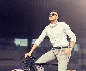 Image showing man with bicycle and headphones on city street