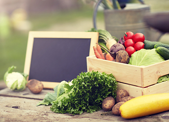 Image showing close up of vegetables with chalkboard on farm