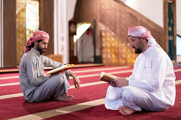 Image showing two muslim people in mosque reading quran together concept of islamic education