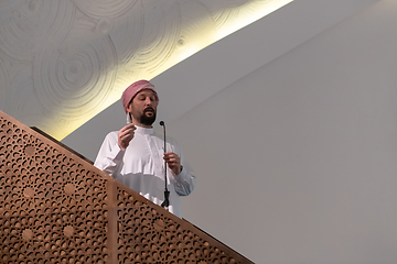 Image showing Muslims young arabic Imam has a speech on friday afternoon prayer in mosque.