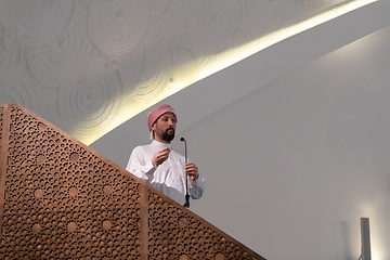 Image showing Muslims young arabic Imam has a speech on friday afternoon prayer in mosque.