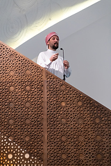 Image showing Muslims young arabic Imam has a speech on friday afternoon prayer in mosque.