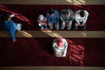 Image showing group of muslim people praying namaz in mosque.