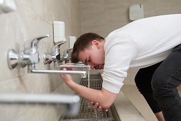 Image showing A Muslim takes ablution for prayer. Islamic religious rite