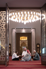 Image showing muslim people in mosque reading quran together